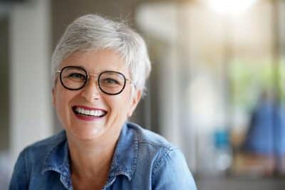 senior woman with all-on-x, smiling, showing off her Full-Arch Replacement smile