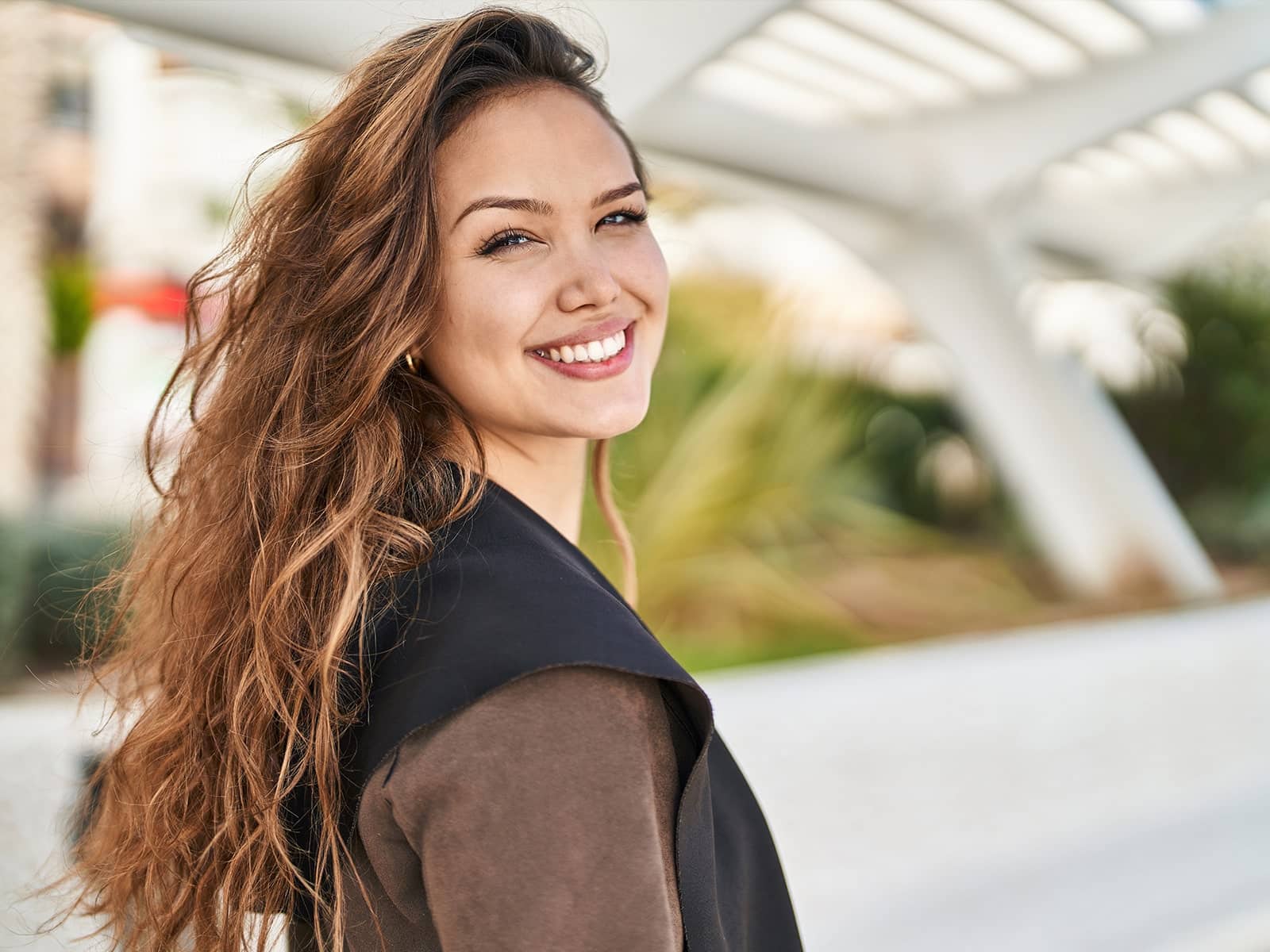 young hispanic woman smiling outdoors