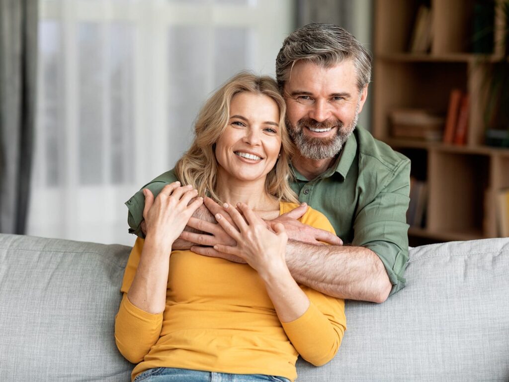 Couple smiling on couch min