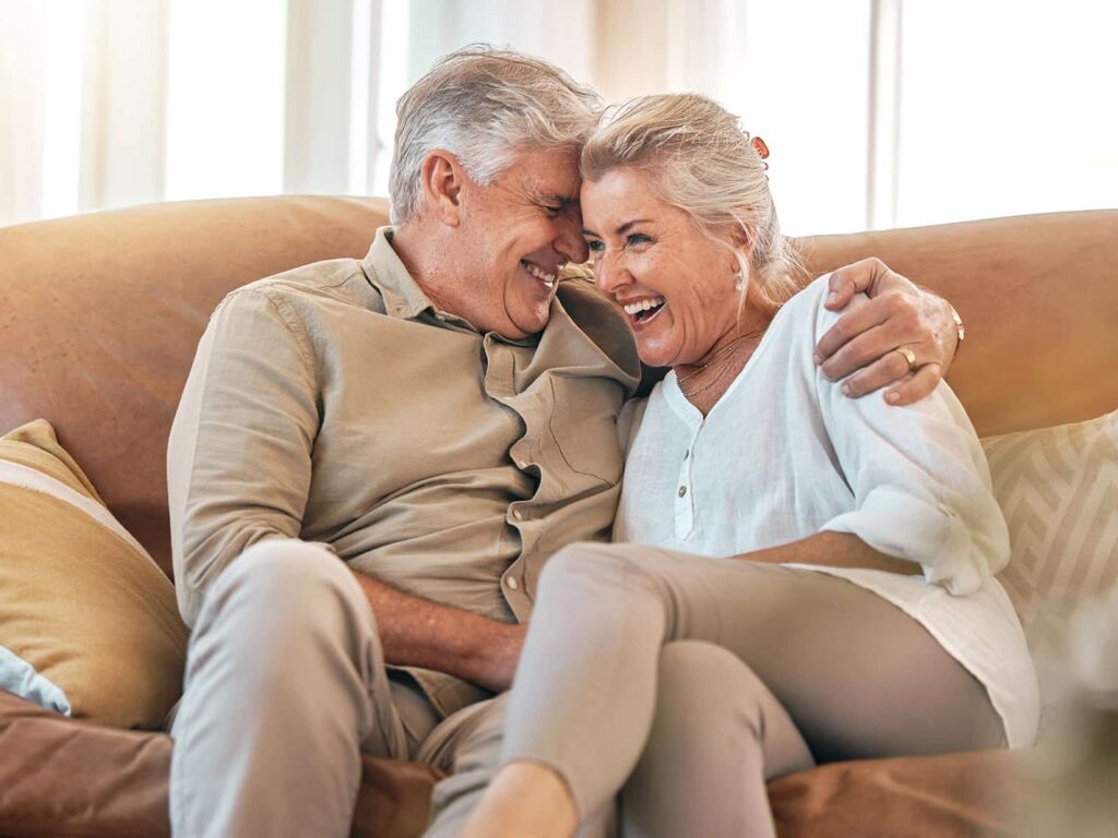 Elderly couple laughing min