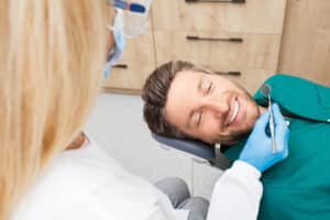 A man undergoing a dental exam for wisdom teeth extraction