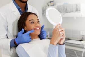 Dentist explaining the different options to a woman choosing between BioClear, veneers, or dental bonding.