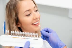 Woman having a consult with her dentist about veneers to fix her fractured tooth.