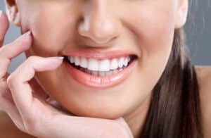 Close up of a woman's bright, white, and straight smile after receiving BioClear treatment
