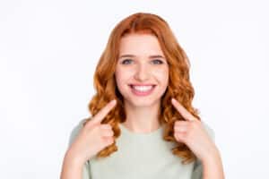 Smiling woman showing off her bright, white smile after getting BioClear to fix tooth gaps.